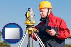 wyoming map icon and a surveyor with transit level equipment
