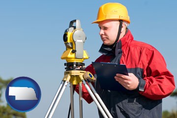 a surveyor with transit level equipment - with Nebraska icon