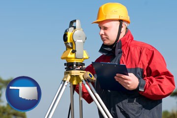 a surveyor with transit level equipment - with Oklahoma icon